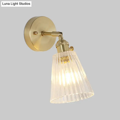 Vintage brass wall sconce with clear ribbed glass shade and LED bulb on Tampa Home & Garden Store