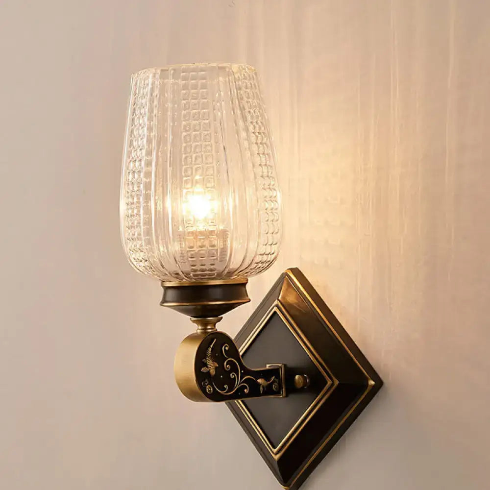 Vintage brass wall sconce with clear textured glass shade on a diamond gold-trim backplate on Tampa Home & Garden Store