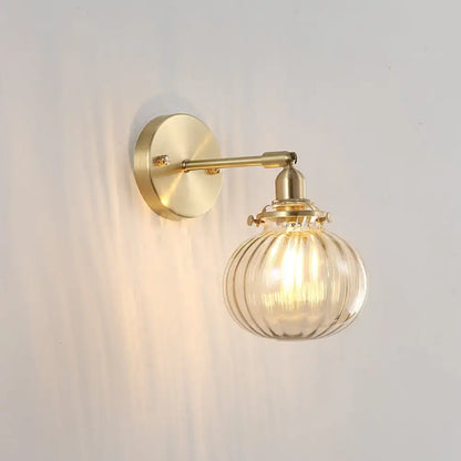 Vintage brass wall sconce with champagne and clear ribbed glass shade on Tampa Home & Garden Store