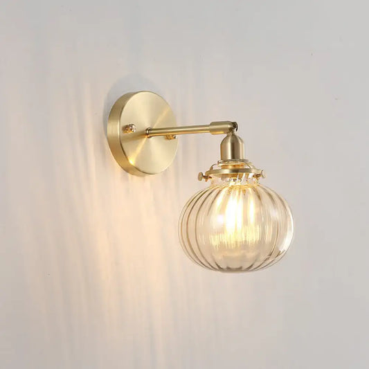 Vintage brass wall sconce with champagne and clear ribbed glass shade on Tampa Home & Garden Store