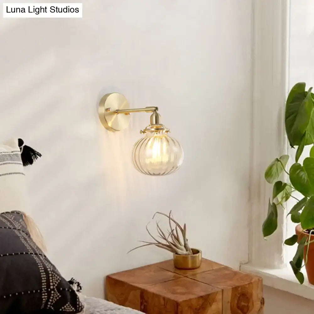 Decorbites brass wall light with champagne and clear glass shade mounted on bedroom wall on Tampa Home & Garden Store