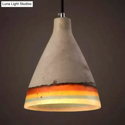 Conic pendant light with a concrete finish and a colorful bottom band in orange and blue on Tampa Home & Garden Store