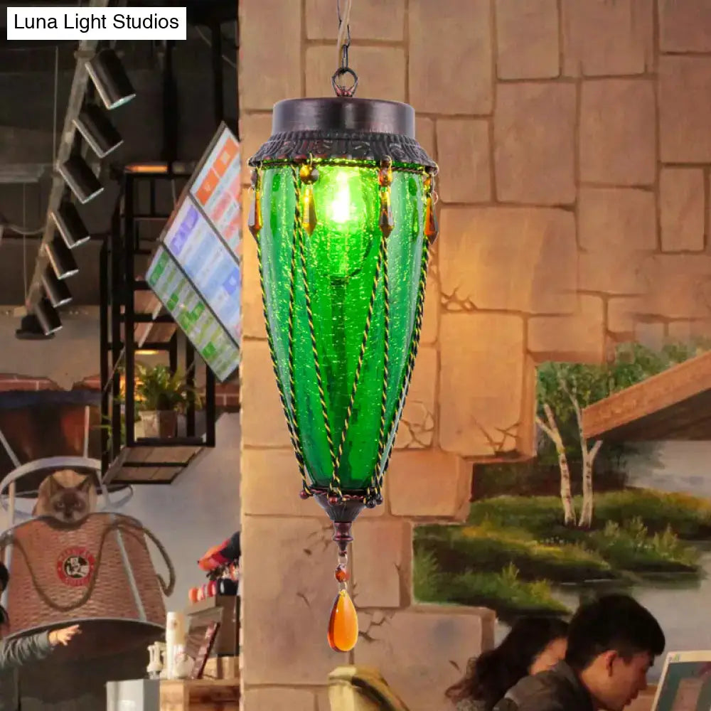 Vintage emerald green glass pendant light with amber beads, metal cap, hanging in showroom on Tampa Home & Garden Store