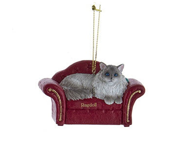 Décoration Chat sur canapé rouge -