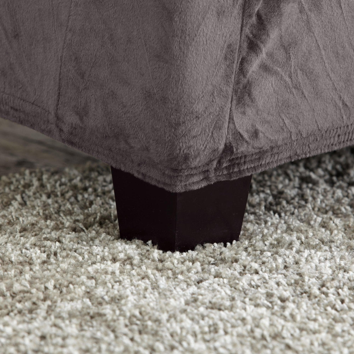 Velvet stretch slipcover Gale Collection gray for Great Bay Home, close-up of hem edge on furniture leg on Tampa Home & Garden Store