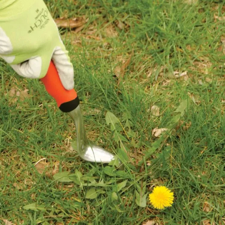 Weeder with cast aluminum blade and orange gel-grip handle in grass on Tampa Home & Garden Store