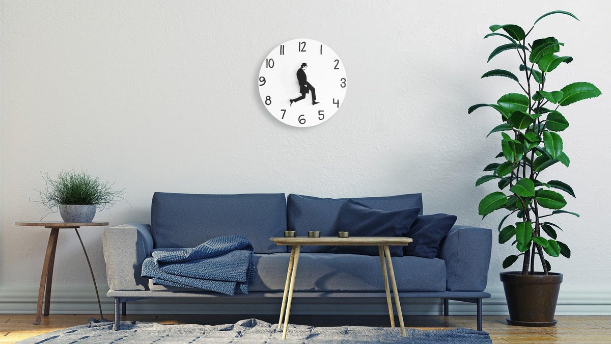 Stevvex wall clock with walking silhouette, white face, black numerals, silent sweep in a room on Tampa Home & Garden Store
