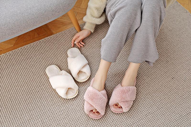Stevvex women's fluffy faux fur cross-band slippers pink open-toe; white pair nearby on beige rug on Tampa Home & Garden Store