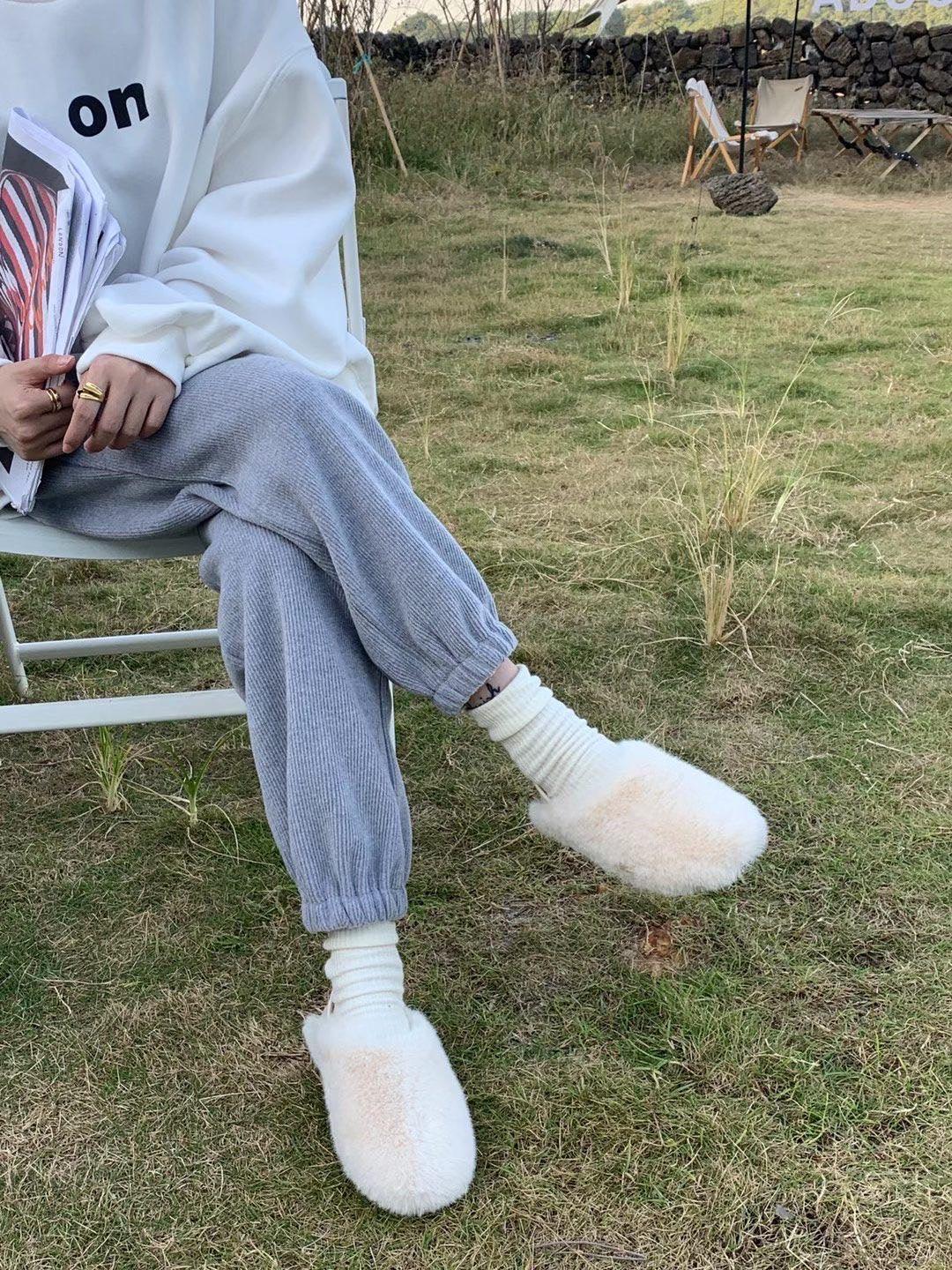 White fluffy fur slippers with round toe, cozy indoor house shoes pair on Tampa Home & Garden Store