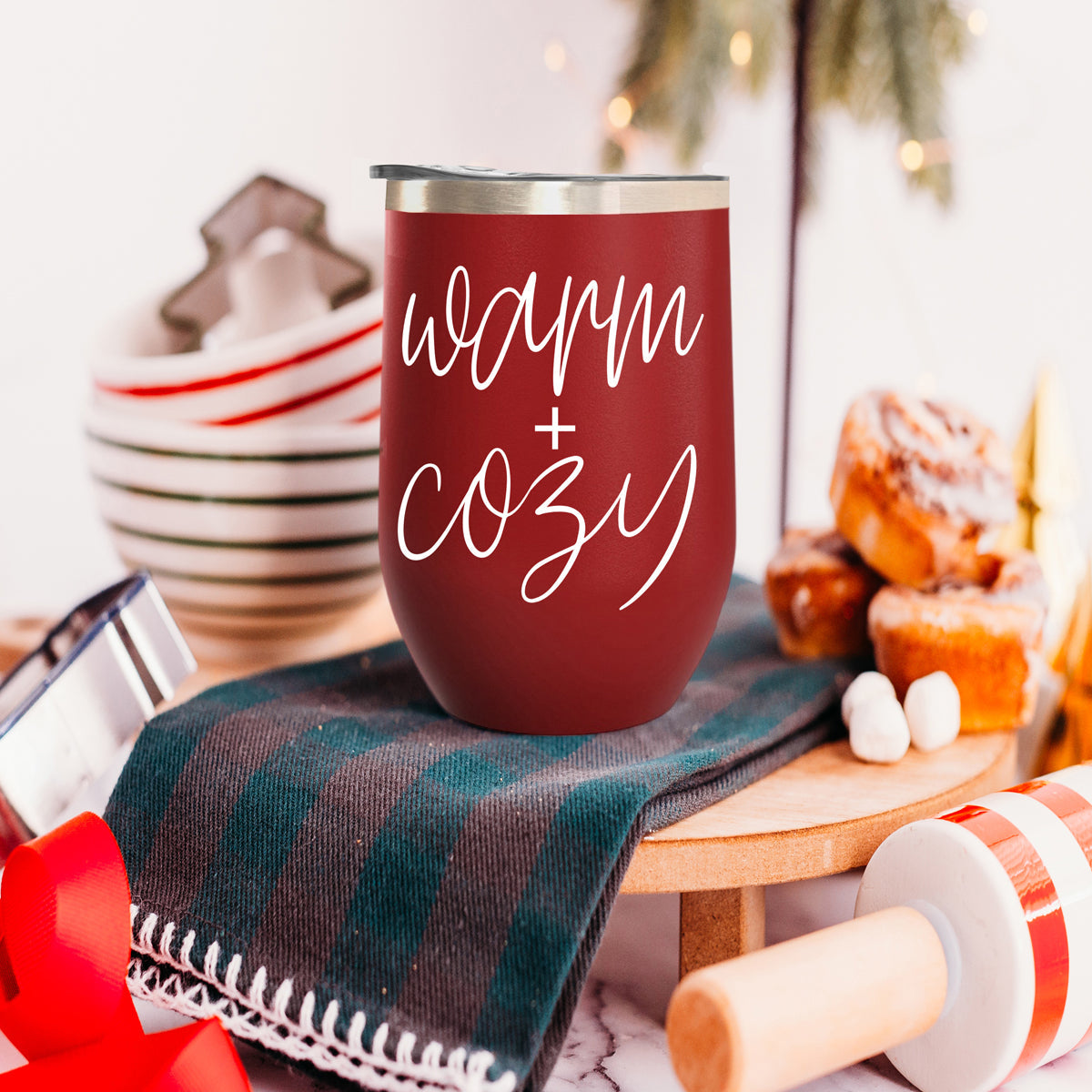 Gia Roma Warm + Cozy 17oz tumbler in red with a silver lid, festive kitchen scene on Tampa Home & Garden Store