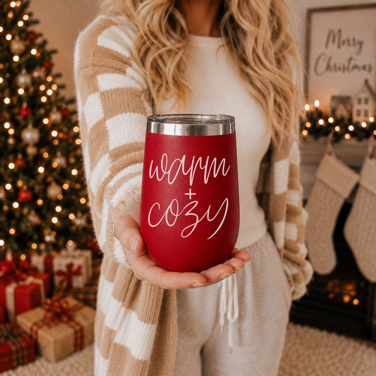 Tumbler Gia Roma Warm + Cozy 17oz red stainless steel with white script, held in a holiday room on Tampa Home & Garden Store