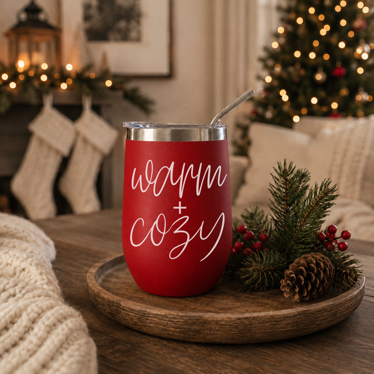 Warm + Cozy 17oz red tumbler with clear lid and straw in a festive holiday scene on Tampa Home & Garden Store