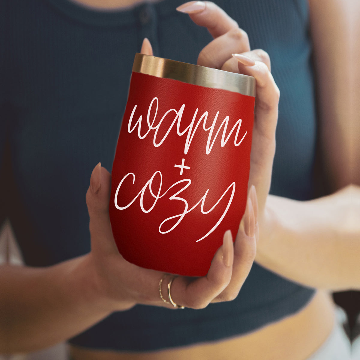 Warm + Cozy 17oz tumbler by Gia Roma in red stainless steel, held by hands on Tampa Home & Garden Store