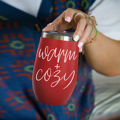 Gia Roma Warm + Cozy 17oz tumbler, red with chrome rim and white script text, held in hand on Tampa Home & Garden Store