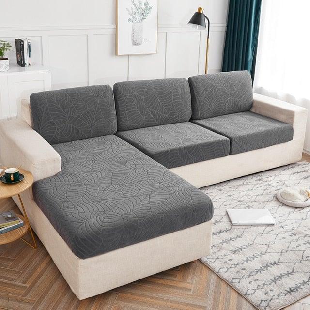 Stevvex waterproof sofa cushion cover in dark gray leaf-patterned fabric on beige sectional on Tampa Home & Garden Store