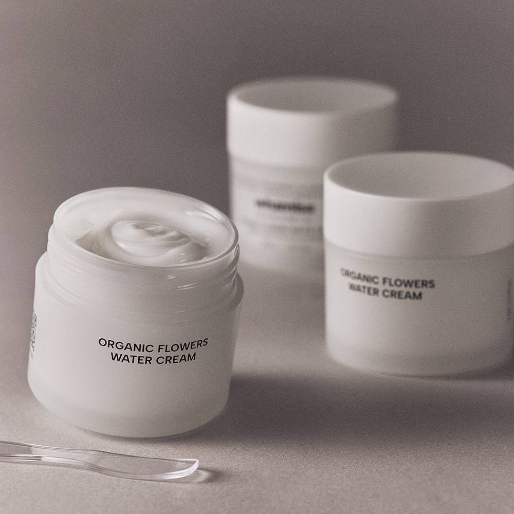 Organic Flowers Water Cream jars, three white plastic containers with minimalist labels on Tampa Home & Garden Store