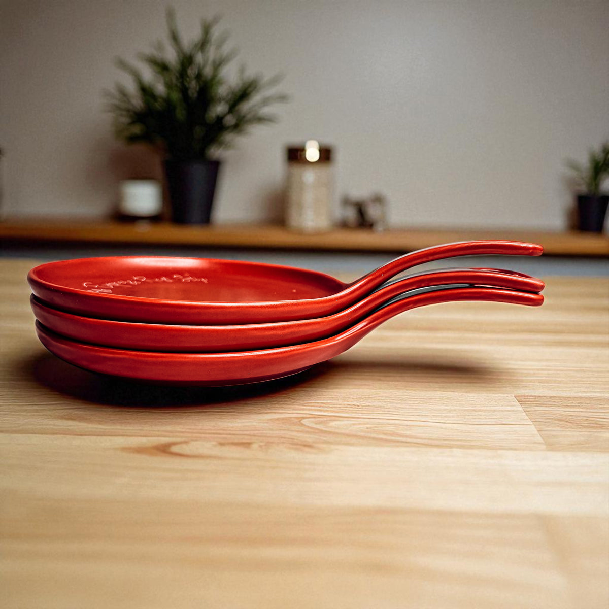 Deck the Halls & Carbs red spoon rests stacked in a trio with curved handles kitchen accessory on Tampa Home & Garden Store