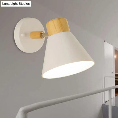 Wall sconce white conical shade with natural wood accent and round backplate on bedroom wall on Tampa Home & Garden Store