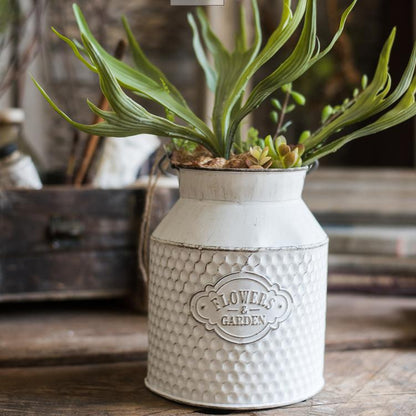 White iron garden barrel planter with texture and embossed seal holding succulents on Tampa Home & Garden Store