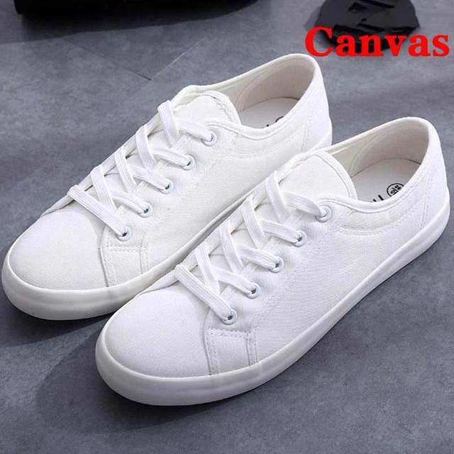 White canvas sneakers with lace-up closure, casual low-top walking shoes, pair on Tampa Home & Garden Store