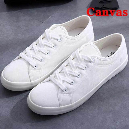 White canvas sneakers with lace-up closure, casual low-top walking shoes, pair on Tampa Home & Garden Store