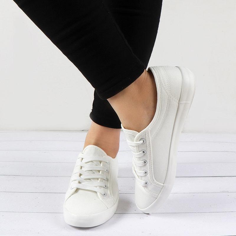 Pair of white Stevvex women's sneakers with lace-up canvas upper, casual walking shoes on Tampa Home & Garden Store