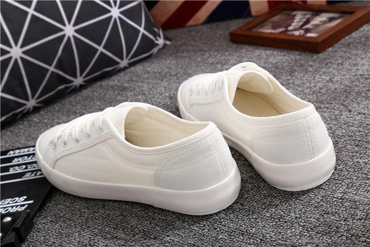 Pair of Stevvex white canvas sneakers with lace-up design and rubber sole on Tampa Home & Garden Store
