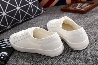 Pair of Stevvex white canvas sneakers with lace-up design and rubber sole on Tampa Home & Garden Store