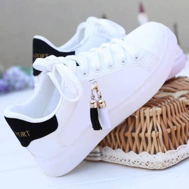Stevvex white sneakers pair, lace-up low-top casual shoes, black heel tab, tassel charm on Tampa Home & Garden Store
