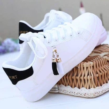Stevvex white sneakers pair, lace-up low-top casual shoes, black heel tab, tassel charm on Tampa Home & Garden Store