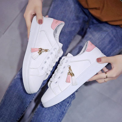 White Stevvex sneakers pair with pink heel tab and tassel charm, lace-up casual flats on Tampa Home & Garden Store