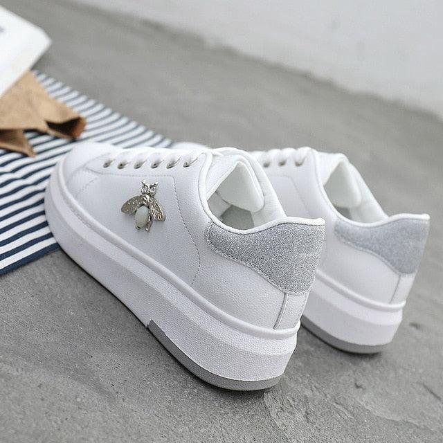 White sneakers pair with patch and rhinestone bee charm on Tampa Home & Garden Store