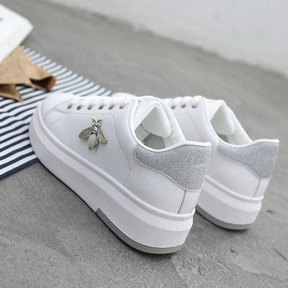 White sneakers pair with patch and rhinestone bee charm on Tampa Home & Garden Store