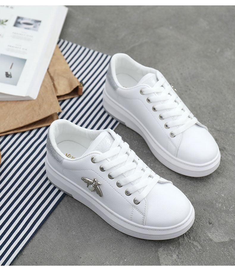 White women's platform sneakers pair with lace-up, white leather, silver bee emblem, chunky sole on Tampa Home & Garden Store