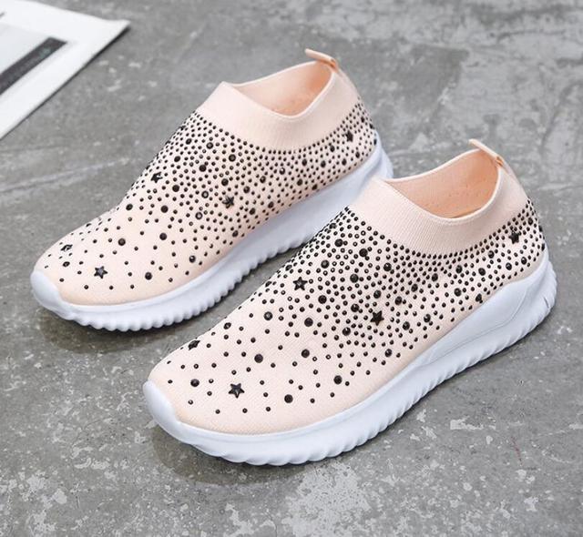 White Stevvex crystal slip-on sneakers pair with black studs on Tampa Home & Garden Store