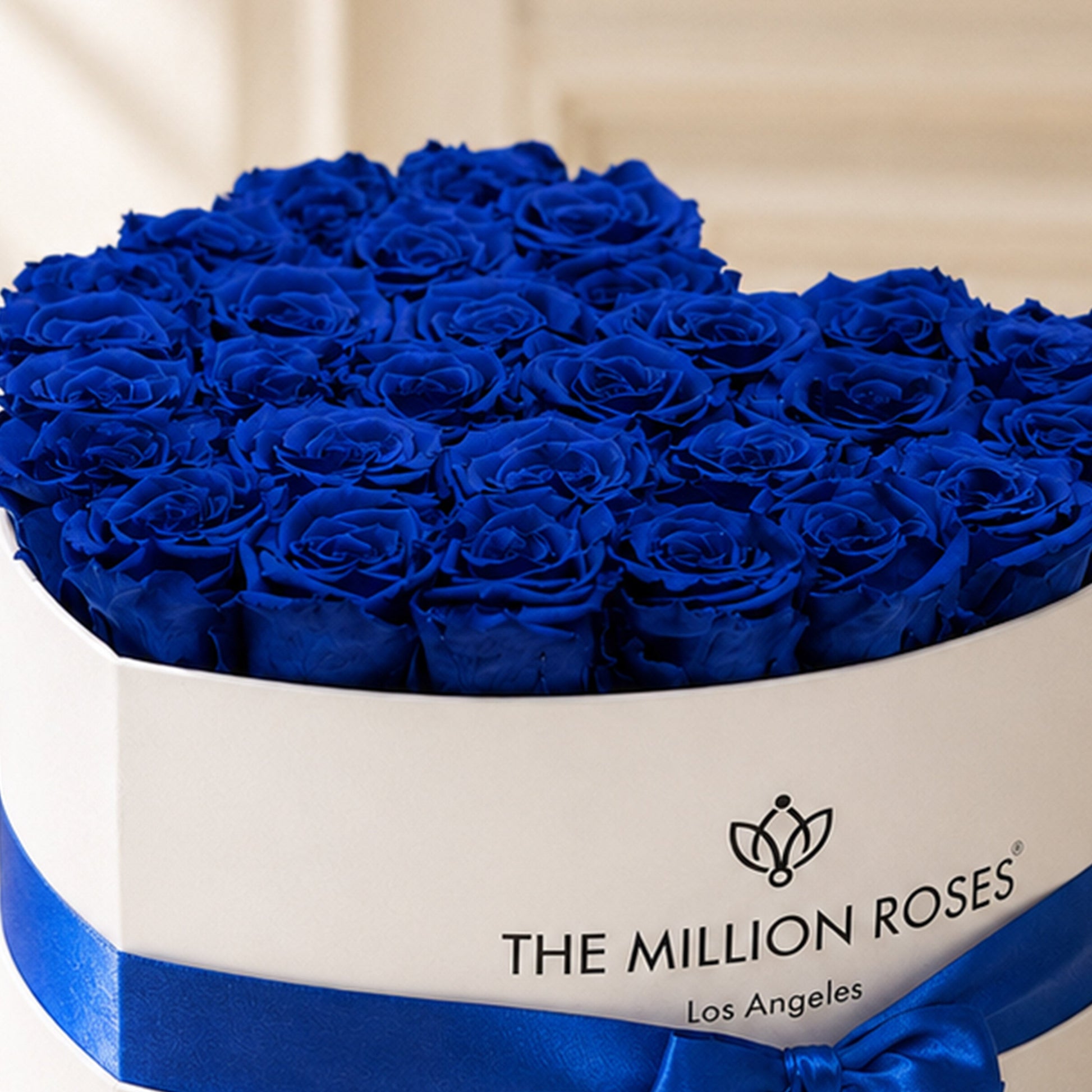 Royal blue eternity roses in a heart white box by The Million Roses on Tampa Home & Garden Store