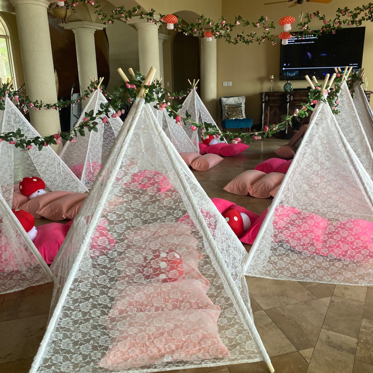 Dainty Lace Kids Teepee Tent in white ivory lace with wooden poles; several play tents indoors with pink cushions on Tampa Home & Garden Store