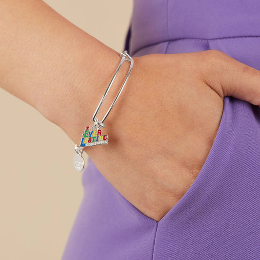Willy Wonka Ever Lasting Gobstopper charm bracelet on a silver bangle worn on purple fabric on Tampa Home & Garden Store
