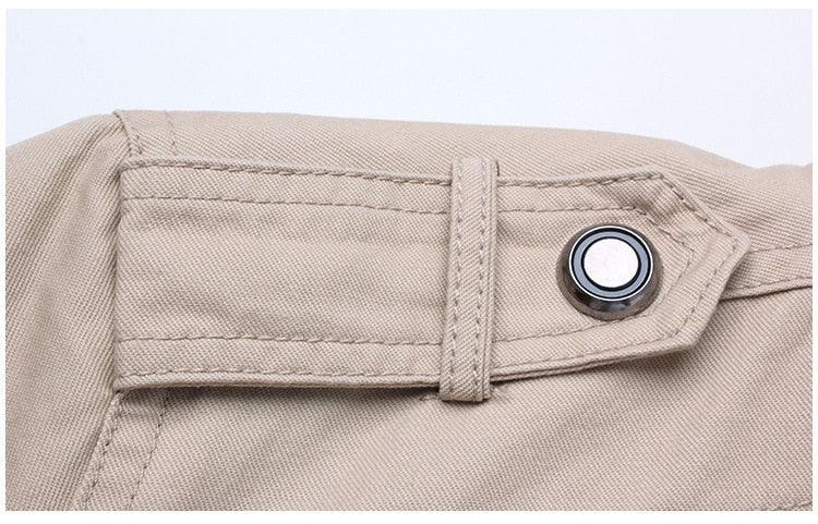 Beige windproof bomber jacket closeup with a strap tab and metal snap button on Tampa Home & Garden Store