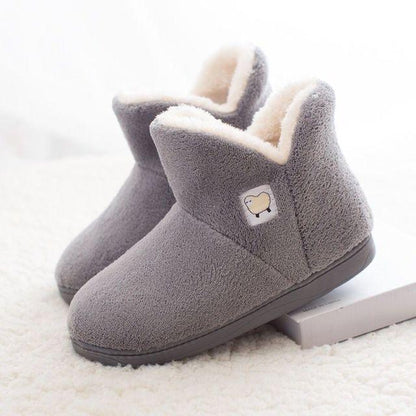 Gray plush women's slippers with white fur lining, closed-back bootie, sheep logo patch on Tampa Home & Garden Store