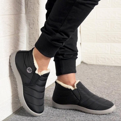 Stevvex waterproof winter boots, black quilted slip-ons with plush fur lining and gray sole on Tampa Home & Garden Store