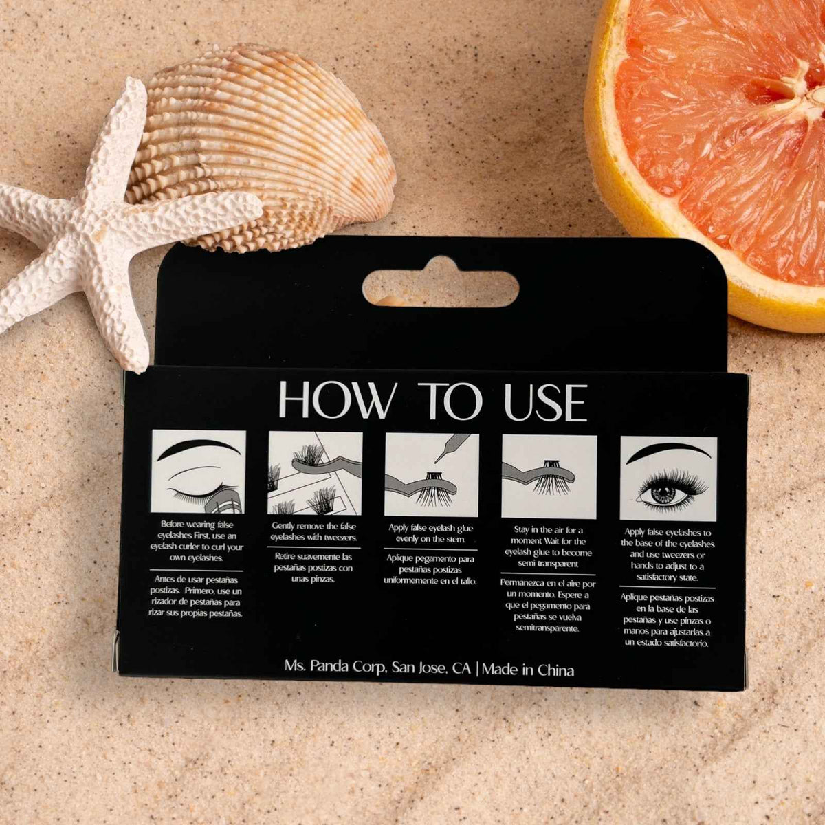 Wispies DIY Lash Extension Kit on a black how-to-use card with seashells and grapefruit on sand on Tampa Home & Garden Store