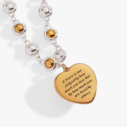 The Wizard of Oz Tin Man Linear Bracelet with silver chain and gold-tone discs on Tampa Home & Garden Store