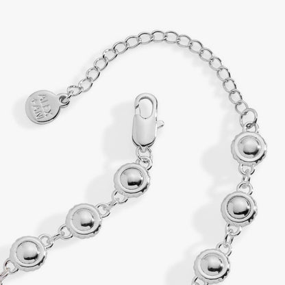 The Wizard of Oz Tin Man Linear Bracelet by ALEX AND ANI, silver-tone bracelet with linked round disc charms and logo tag on Tampa Home & Garden Store