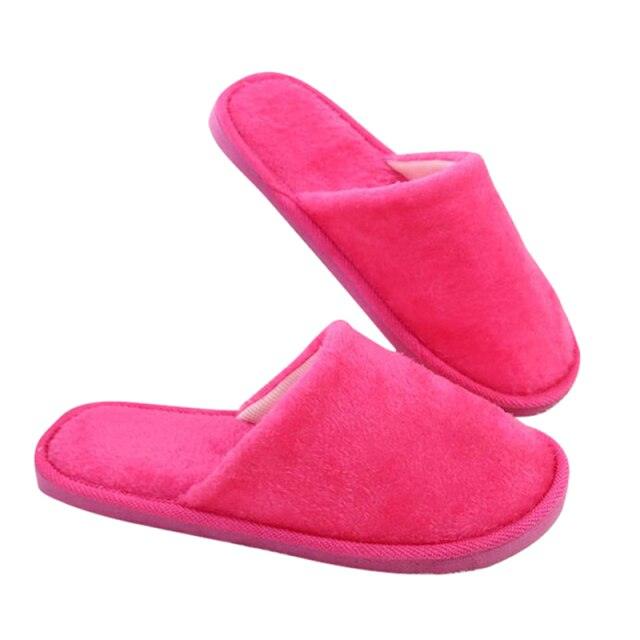 Pair of pink plush fuzzy slip-on slippers with wide strap for indoor warmth on Tampa Home & Garden Store