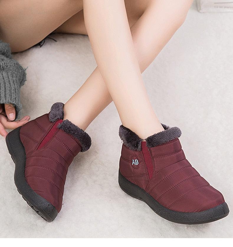 Pair of burgundy Stevvex women's waterproof fur-lined ankle boots with AB logo on Tampa Home & Garden Store