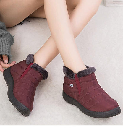 Pair of burgundy Stevvex women's waterproof fur-lined ankle boots with AB logo on Tampa Home & Garden Store