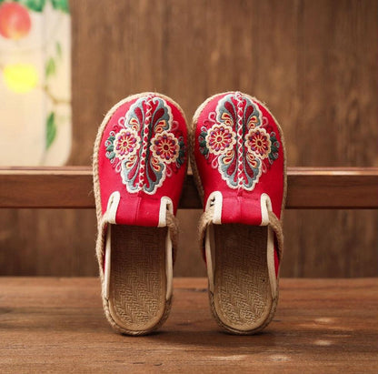 Pair of red linen embroidered mules with floral patterns, espadrille-style slippers on Tampa Home & Garden Store