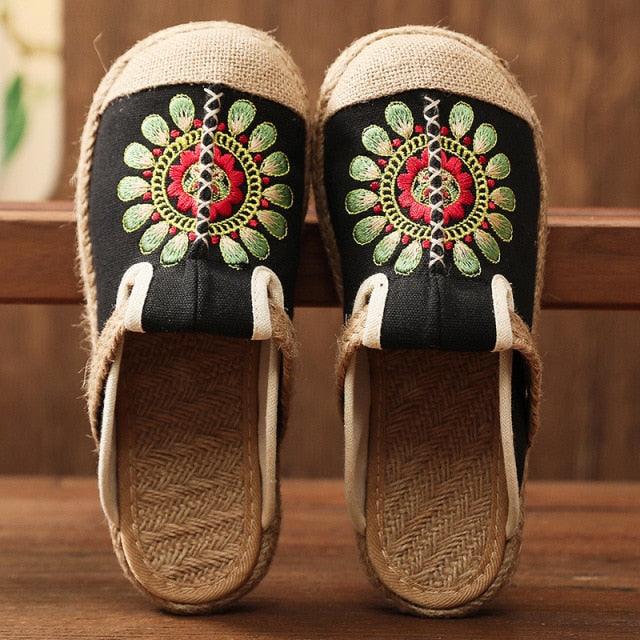 Women’s black linen mules with green-red floral embroidery and jute espadrille sole, pair shown on Tampa Home & Garden Store