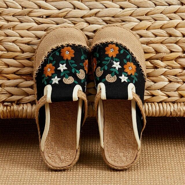 Pair of Stevvex linen mules with floral embroidery on black canvas upper beige jute soles on Tampa Home & Garden Store